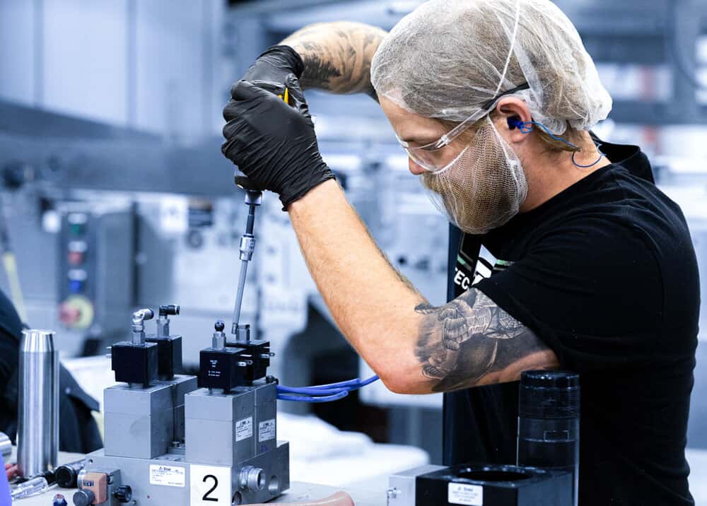 PS Tec technicians servicing industrial equipment